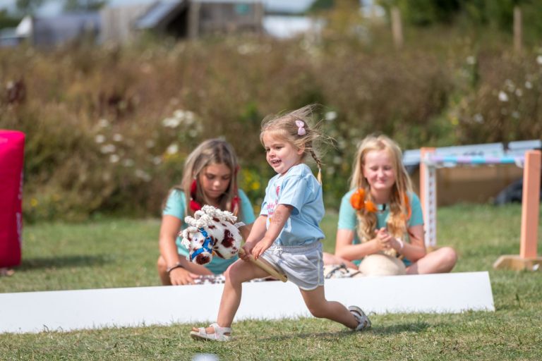 Little girl riding hobby horse