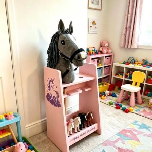 The pink 2 stall stable with a hobby horse inside, shelf at the bottom.